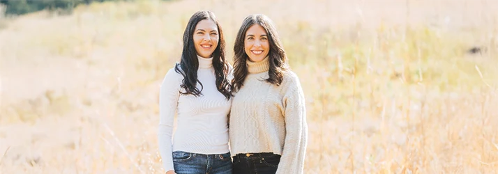 Megan Nelsen and Amy Fitzgearlds Stand Together Outside in a Field